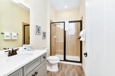 a bathroom with a toilet and a sink and a shower at Palm Tree Paradise Cottage Near Disney With Margaritaville Resort & Island H20 Waterpark Access - 3087Pi in Orlando
