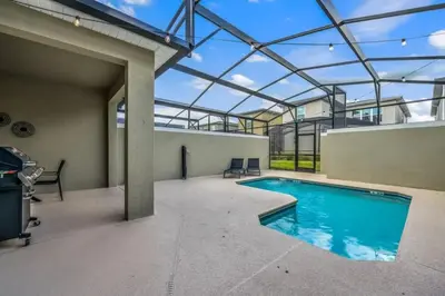 an indoor swimming pool with a glass roof at 2416 Luxo & Magia: Casa com Piscina no Storey Lake! in Kissimmee