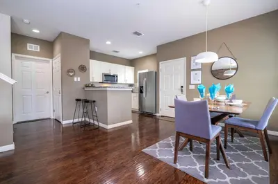 a kitchen and dining room with a table and chairs at Spacious 4Bd Disney Dream with Resort Access at Lucaya 3210 in Kissimmee