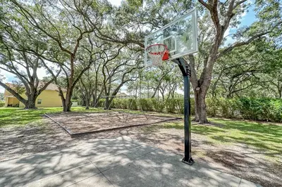 a basketball hoop in a park with a tree at Stunning 3 bedroom 3 bath townhome 370 in Kissimmee