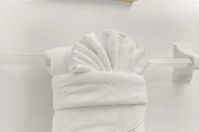 a pile of towels on a towel rack in a bathroom at Family favorite Disney pool home in Kissimmee