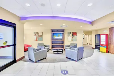 a waiting room at a hospital with chairs and tables at 1BR Suite Near Universal Studios w Pool & Hot Tub in Orlando