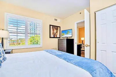a bedroom with a large white bed and a window at King Suite w Pool & Hot Tub Near Disney in Orlando