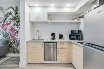 a kitchen with a sink and a refrigerator at Condo close to Epic Universe and Universal Studios in Orlando