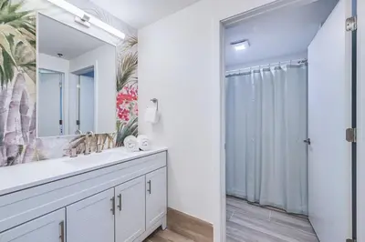 a bathroom with a sink and a mirror at Condo close to Epic Universe and Universal Studios in Orlando
