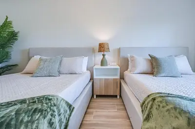 two beds sitting next to each other in a bedroom at Condo close to Epic Universe and Universal Studios in Orlando