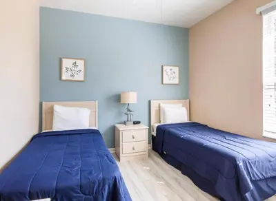 two beds in a bedroom with blue walls at Making Memories At Windsor Palms Resort, Great Amenities And Much More Fun! in Kissimmee