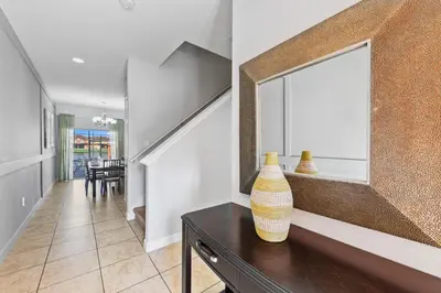 a room with a mirror and a vase on a table at 8893 Candy Palm Road in Kissimmee