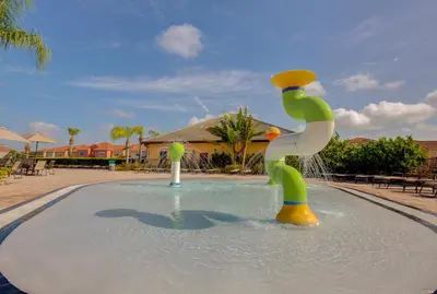 a fountain in a pool with a person in the water at 8893 Candy Palm Road in Kissimmee