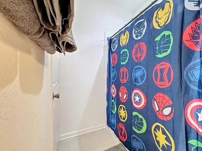 a door with marvel stickers on it in a room at Free Water Park-Close to Disney-3 King-POOL-SPA in Orlando