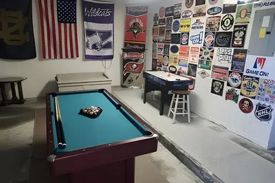 a room with a pool table and a wall with stickers at Lake View Pool Home near Disney and Shoppings in Kissimmee