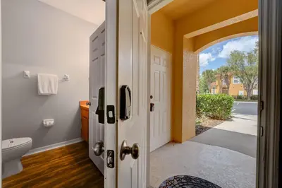a bathroom with a toilet and an open door at Family Retreat Near Disney in Emerald Island in Kissimmee