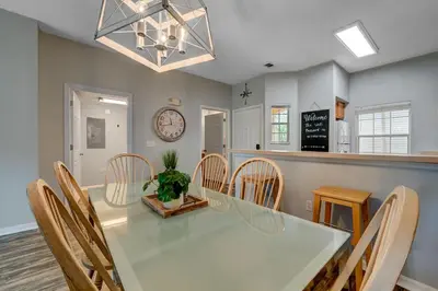 a dining room with a white table and chairs at Family Retreat Near Disney in Emerald Island in Kissimmee