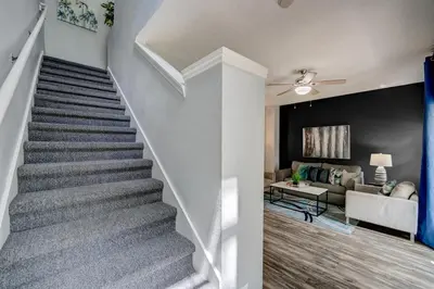 a staircase in a home with a living room at Family Retreat Near Disney in Emerald Island in Kissimmee