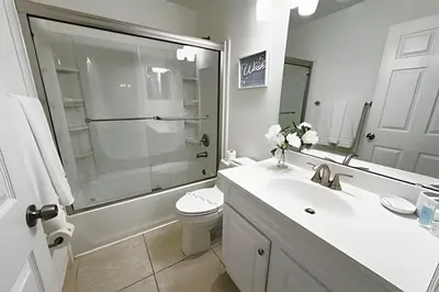 a bathroom with a sink and a toilet and a shower at Lakeside Pool Home, Games close to Disney & Malls in Kissimmee