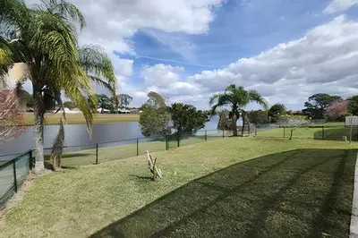 a park with palm trees and a body of water at Lakeside Pool Home, Games close to Disney & Malls in Kissimmee