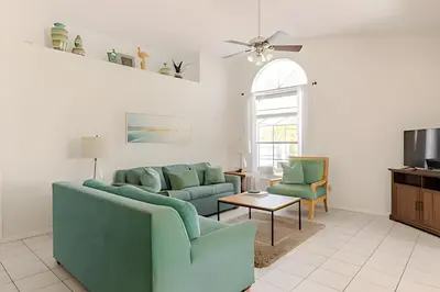 a living room with a couch and chairs and a table at Lakeside View Pool Home, close to Disney, Malls in Kissimmee
