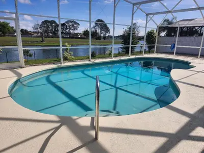 a large swimming pool with blue water at Central Location Lakeview Pool Villa near Disney in Kissimmee