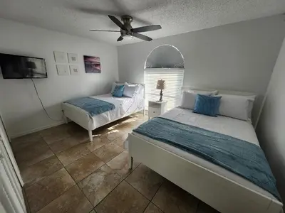 a bedroom with two beds and a ceiling fan at Central Location Lakeview Pool Villa near Disney in Kissimmee