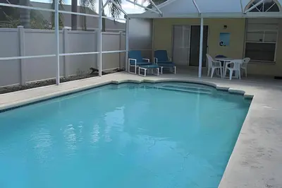 a large pool with blue water in a building at 10 Minutes to Disney! Pool Home Large Lot in Kissimmee