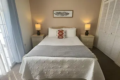 a bedroom with a large bed with two night stands at 10 Minutes to Disney! Pool Home Large Lot in Kissimmee