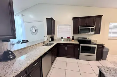 a kitchen with a sink and a stove top oven at 10 Minutes to Disney! Pool Hom, Large Backyard in Kissimmee
