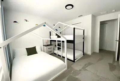 a bedroom with two bunk beds and a staircase at Luxurious Home w/ Pool Near Disney in Kissimmee
