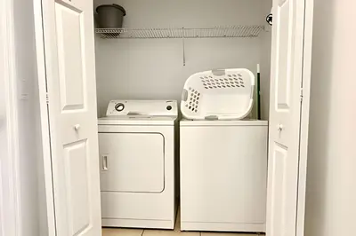 a laundry room with a washer and dryer at Bella Vida Resort Pool Home near Disney in Kissimmee