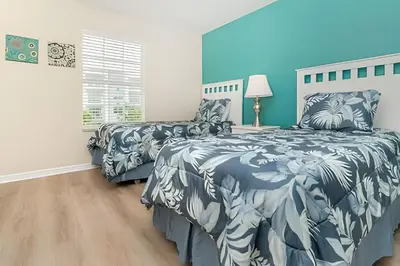 a bedroom with two beds and a lamp on a table at Storey Lake Private Pool Home Near Disney in Kissimmee