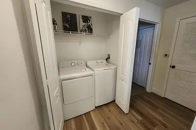a white washer and dryer in a small room at Runaway Beach Club Condo near Disney in Kissimmee