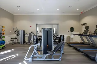 a gym with rows of tread machines in a room at Vista Cay Spacious Convention Center/Disney in Orlando