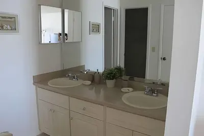a bathroom with two sinks and a large mirror at Premium Pool Villa Centrally Located near Disney in Kissimmee