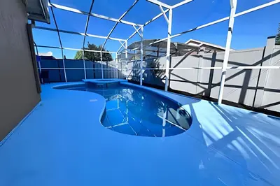 a swimming pool in a building with a glass ceiling at Corner Lot Pool Home Central Located near Disney in Kissimmee