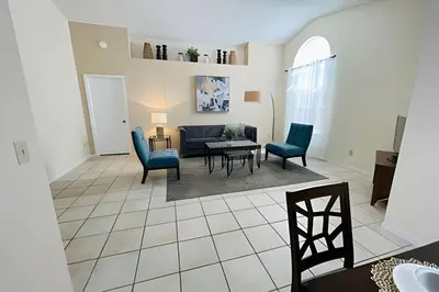 a living room with a couch and chairs and a table at Huge Lot, Private Pool Home Centrally Located in Kissimmee