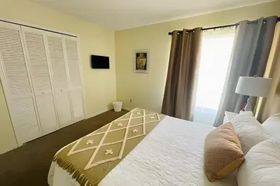 a bedroom with a large bed and a window at Huge Lot, Private Pool Home Centrally Located in Kissimmee