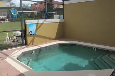 a large swimming pool in a house with a window at Encantada Resort, Pool, close to Disney in Kissimmee