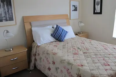 a bedroom with a bed with two night stands and two lamps at Encantada Resort, Pool, close to Disney in Kissimmee