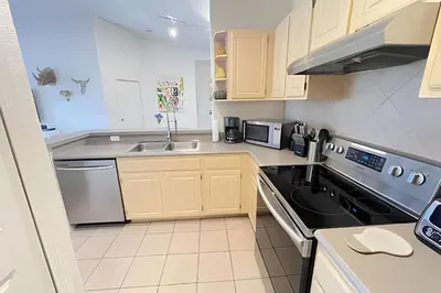 a kitchen with a sink and a stove at Cozy & Bright Condo in Legacy Dunes near Disney in Kissimmee