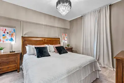 a bedroom with a large white bed and a chandelier at NEW 4Bedrooms At LucayaClose to Disney in Kissimmee