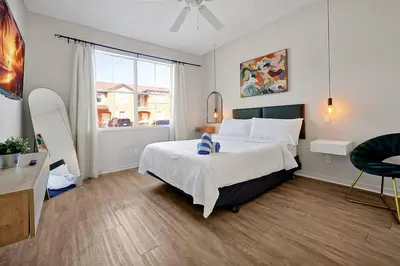 a bedroom with a large bed and a window at Resort Access and Great Location in Orlando