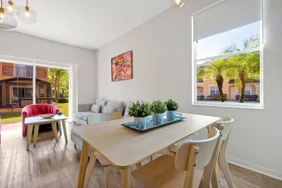 a dining room with a table and a couch at Resort Access and Great Location in Orlando