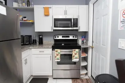 a kitchen with a stove and a microwave at Private 1 Bed 1 Bath Orlando Oasis Shopping and Parks Nearby in Orlando