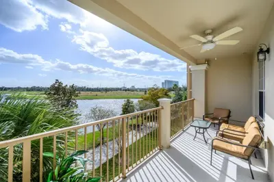 a balcony with a view of the water at Epic Universe Vista Cay Lakeview Condo - 1019 in Orlando