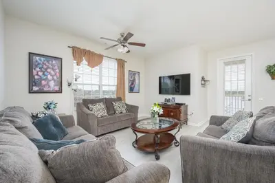 a living room with couches and a table at Epic Universe Vista Cay Lakeview Condo - 1019 in Orlando