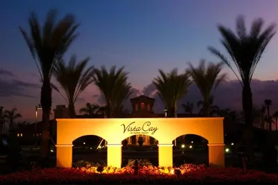 a sign for a hotel with palm trees in the background at Stunning Vacation Condo - Vista Cay Resort - 2008 in Orlando
