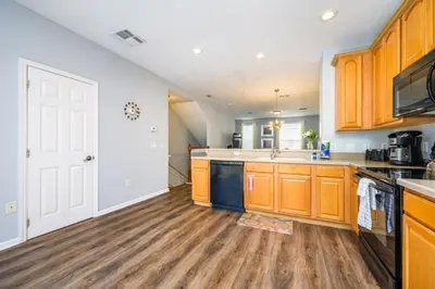 a kitchen with wooden cabinets and a counter top at Epic Universe New Modern Townhome, Near The Parks - 4029 in Orlando