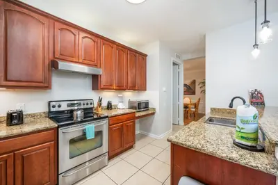 a kitchen with wooden cabinets and a stove top oven at Beautiful Lakeview Condo, New Listing -1024 in Orlando