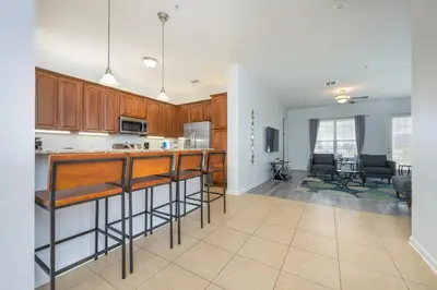an open kitchen and living room in a home at Stunning Epic Universe Condo - Vista Cay Resort - 2016 in Orlando