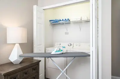 a laundry room with a table and a washing machine at Beautiful Family Townhome, Near The Parks - 4032 in Orlando