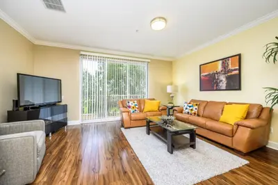 a living room with a couch and a tv at New Modern Townhome, Near The Parks - 4030 in Orlando